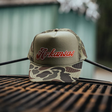 Green camouflage trucker hat with 'Arkansas' in red product shot