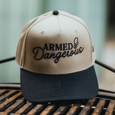 Khaki and black cap with 'Armed & Dangerous' text product shot