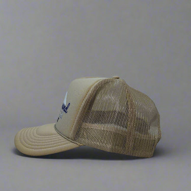 Khaki trucker hat with 'Truck Around & Find Out' text and mountain design on a gray background left view