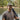 Man holding a rifle wearing Smoke & Steel green hat with rope with duck design. Stuttgart Arkansas