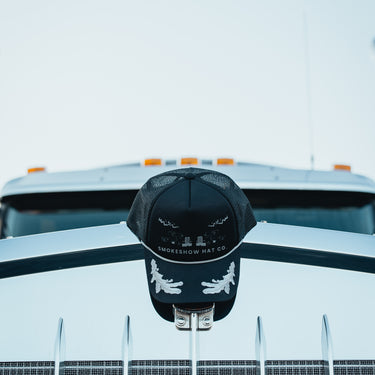 Midnight Convoy Trucker Hat on Truck Hood