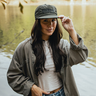 Olive green hat with blowin smoke text and duck call with smoke detail on model
