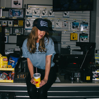 carrying your love with me trucker hat model on counter