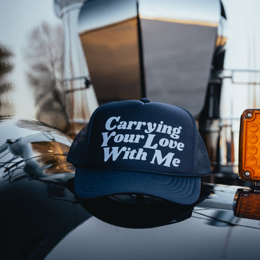 carrying your love with me trucker hat on truck