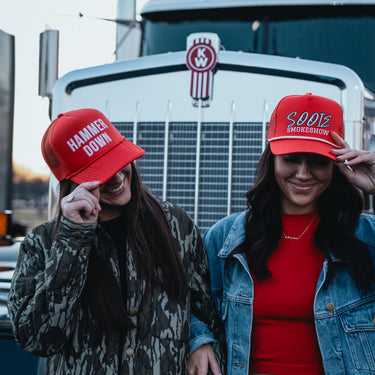 hammer down left lane trucker hat models in front of kenworth