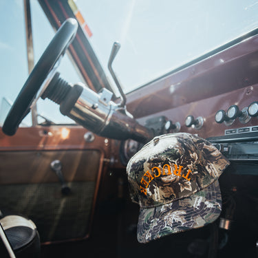modern trucker hat on gear shift